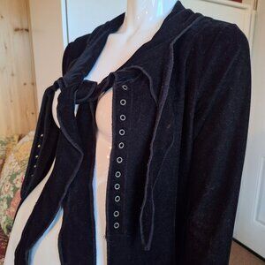 Long, black, asymmetrical coat/jacket with open front.